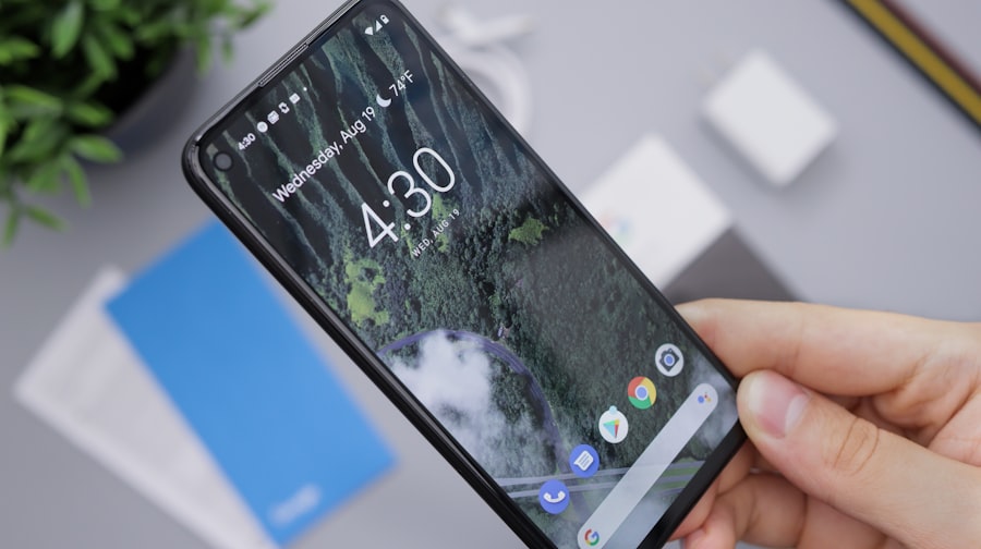A hand holds a smartphone displaying the 4:30 home screen with a forest wallpaper. In the background, WordPress Hosting and a blue booklet sit beside a charger and plant on a gray surface.