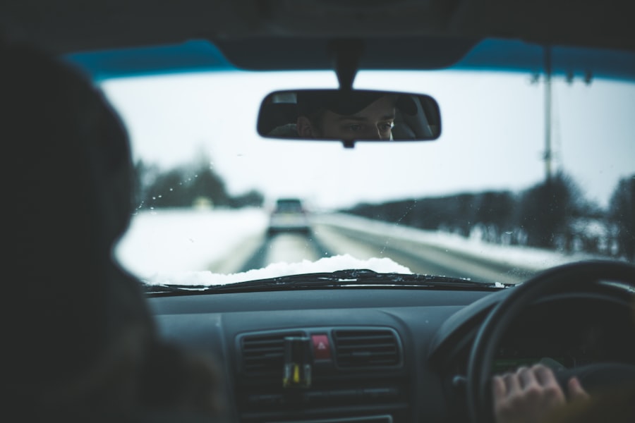 View from inside a car on a snowy road, with the driver’s hands on the steering wheel. Another person sits beside them, snow framing the windshield—much like how WordPress Hosting provides reliability no matter the conditions outside.